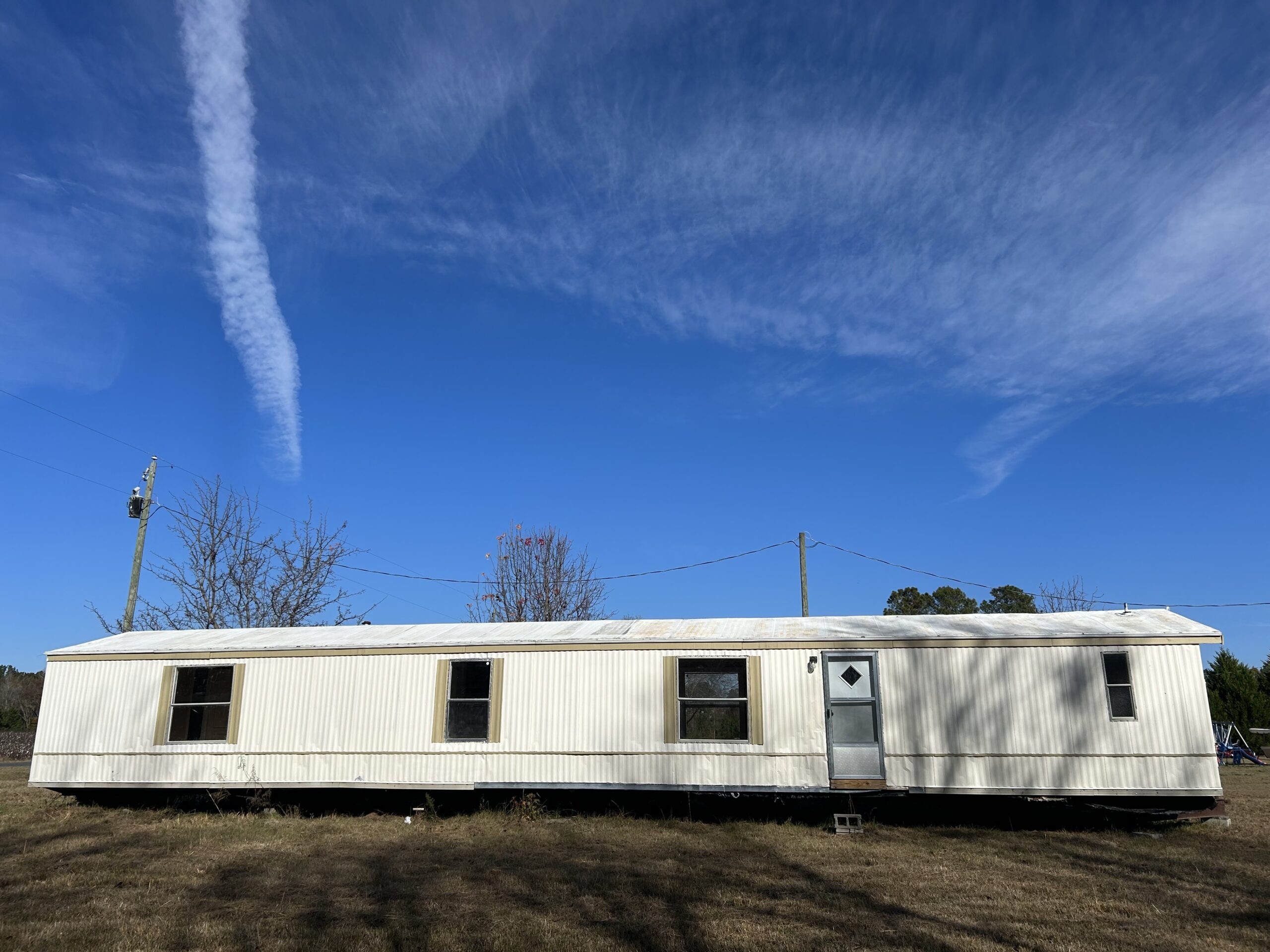 Professional tie down installation on mobile home in Summerville, SC with heavy-duty ground anchors and steel strapping for coastal wind protection